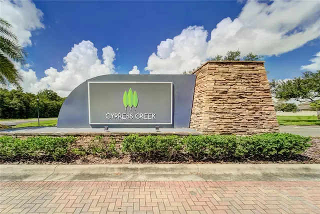 a front view of a house with a yard and potted plants