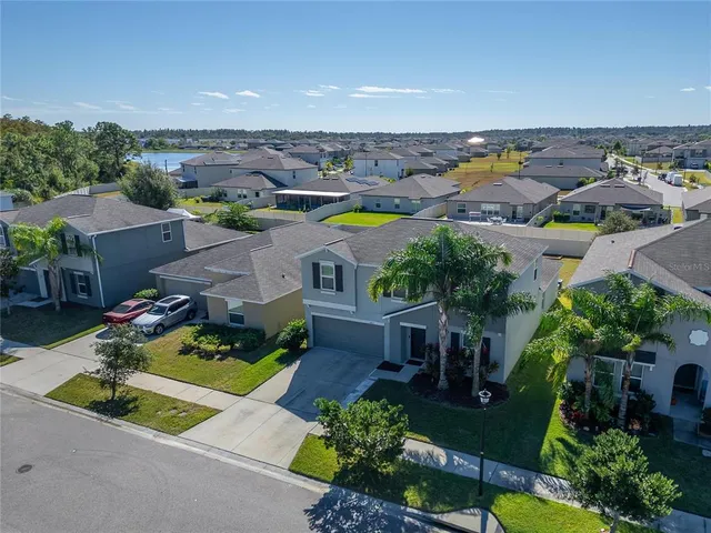 an aerial view of a house with swimming pool outdoor seating and yard
