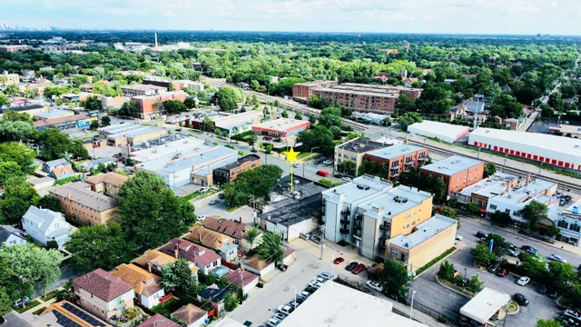 an aerial view of multiple houses with yard
