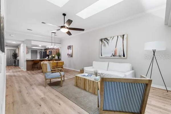 a view of a room with chandelier and wooden floor