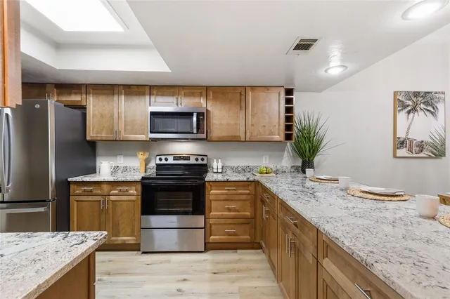 a kitchen with a sink stove and microwave