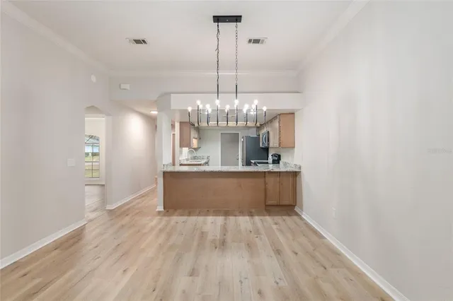a spacious bathroom with a granite countertop sink and a mirror