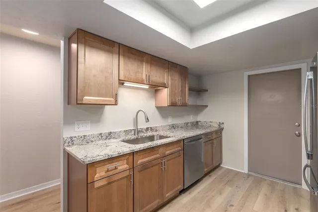 a bathroom with a granite countertop toilet sink and mirror