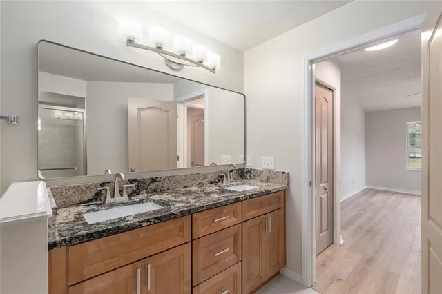 an aerial view of a house with a yard and mountain view in back