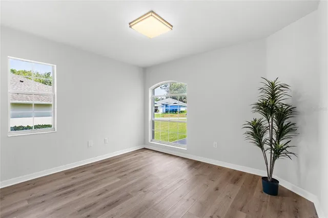 a view of a field with trees in the background