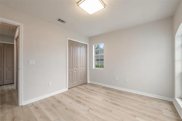 a swimming pool with trees in the background