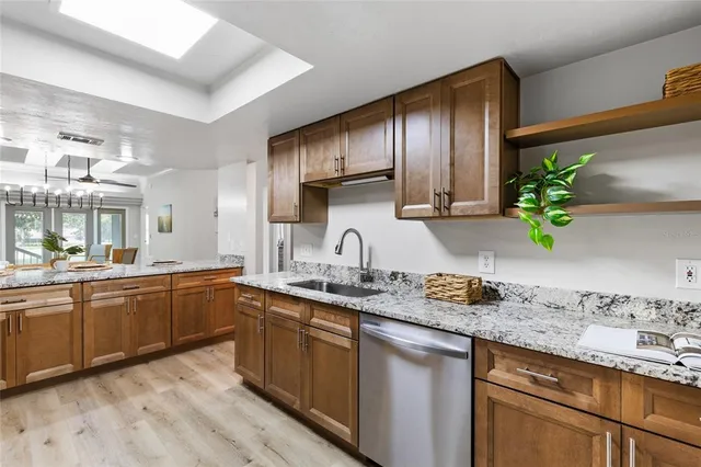 a view of a dining room with furniture a chandelier and wooden floor