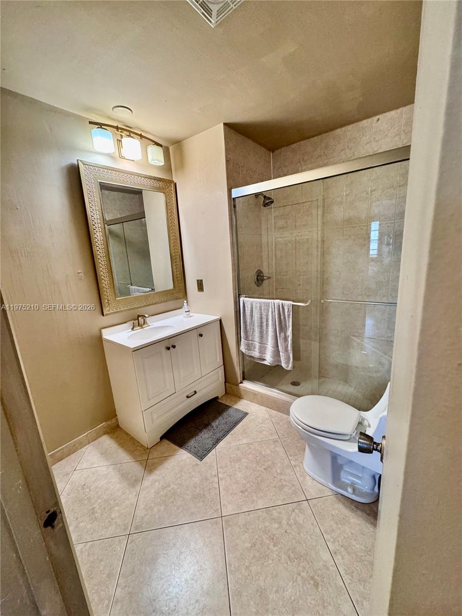 8838 Bella Vista Drive Boca Raton, FL 33433 - Photo 10 of 11 a bathroom with a sink toilet and shower