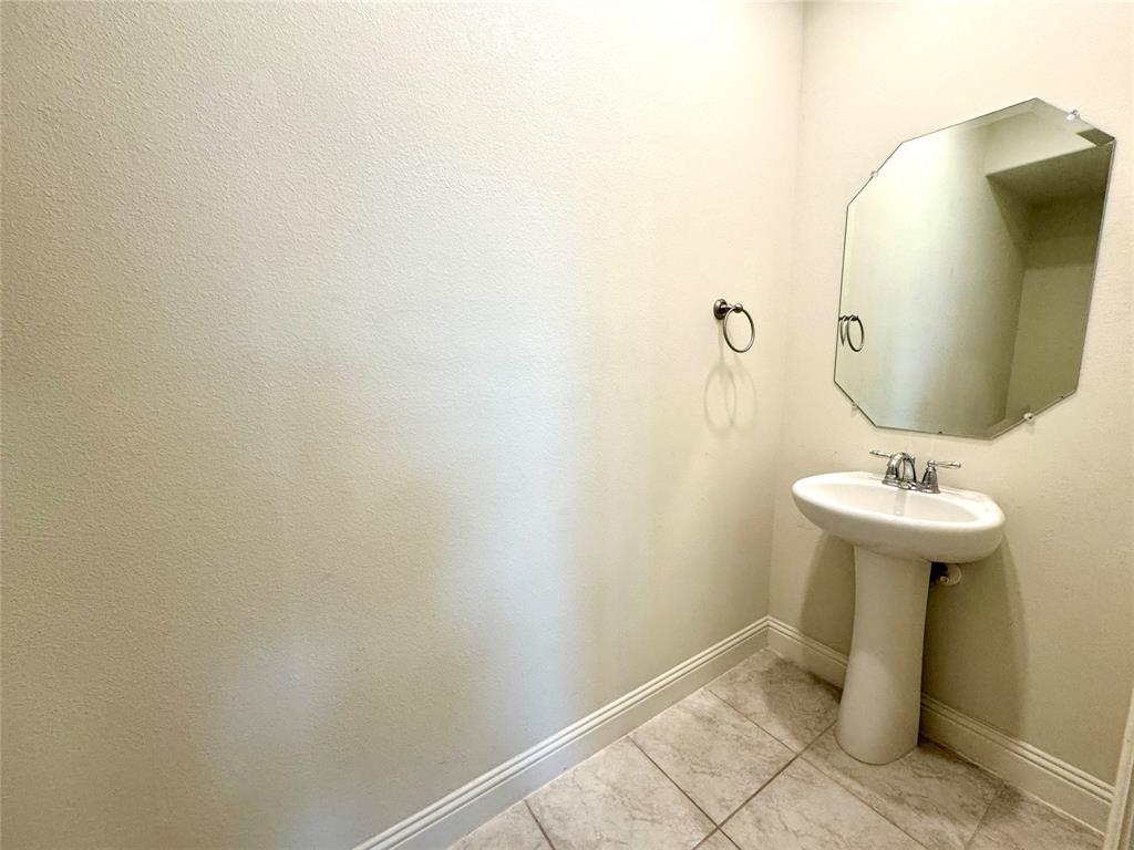 7216 Wildflower Way Little Elm, TX 76227 - Photo 11 of 22 a bathroom with a sink and mirror
