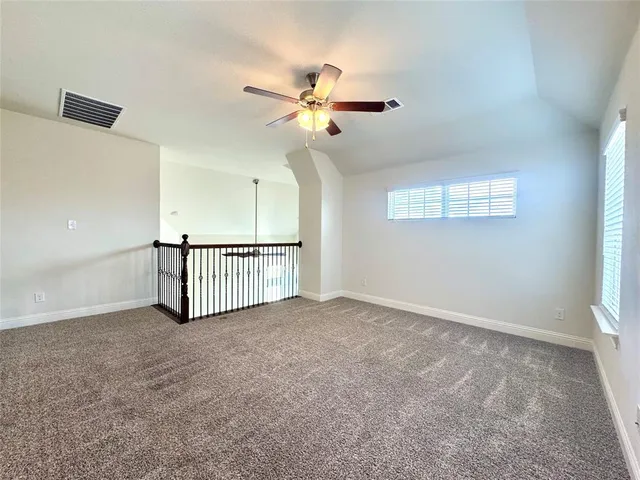 an view of a livingroom with a ceiling fan and window