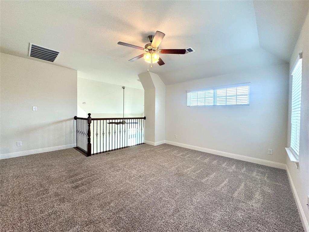 7216 Wildflower Way Little Elm, TX 76227 - Photo 12 of 22 an view of a livingroom with a ceiling fan and window