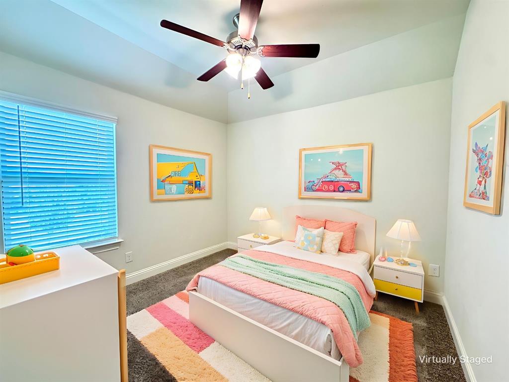 7216 Wildflower Way Little Elm, TX 76227 - Photo 13 of 22 a bedroom with a bed and a chandelier