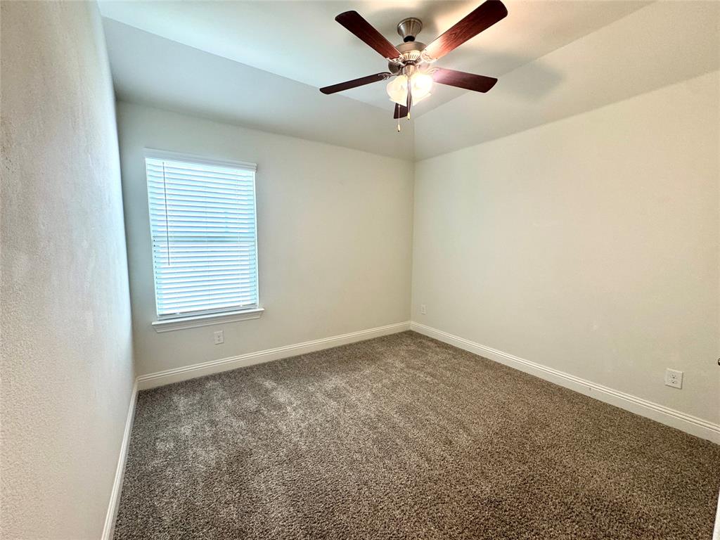 7216 Wildflower Way Little Elm, TX 76227 - Photo 18 of 22 an empty room with a window and a fan
