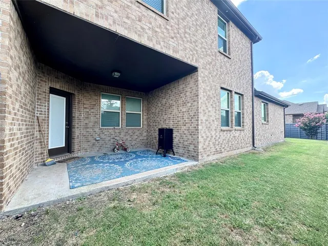 a view of a house with a backyard and porch