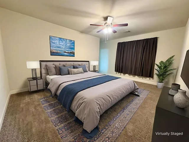 a bedroom with a bed and a painting on the wall