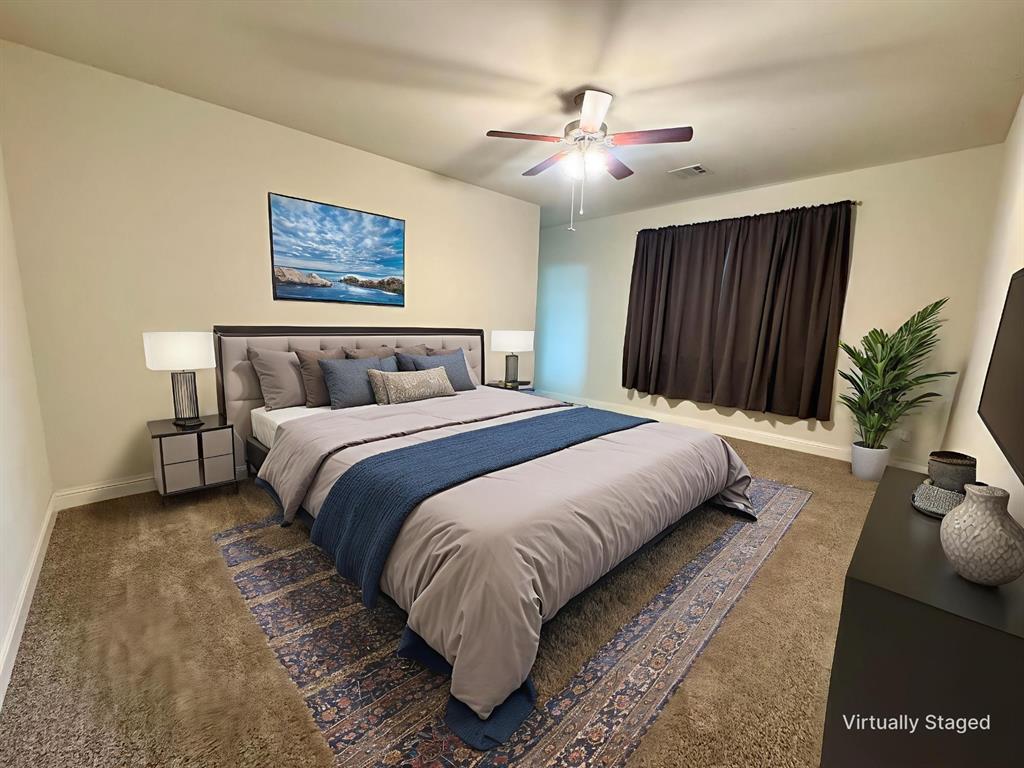 7216 Wildflower Way Little Elm, TX 76227 - Photo 5 of 22 a bedroom with a bed and a painting on the wall