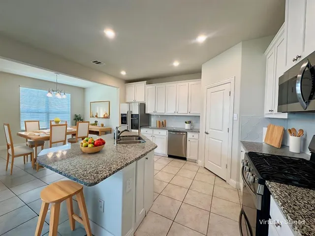 a kitchen with sink cabinets and stove