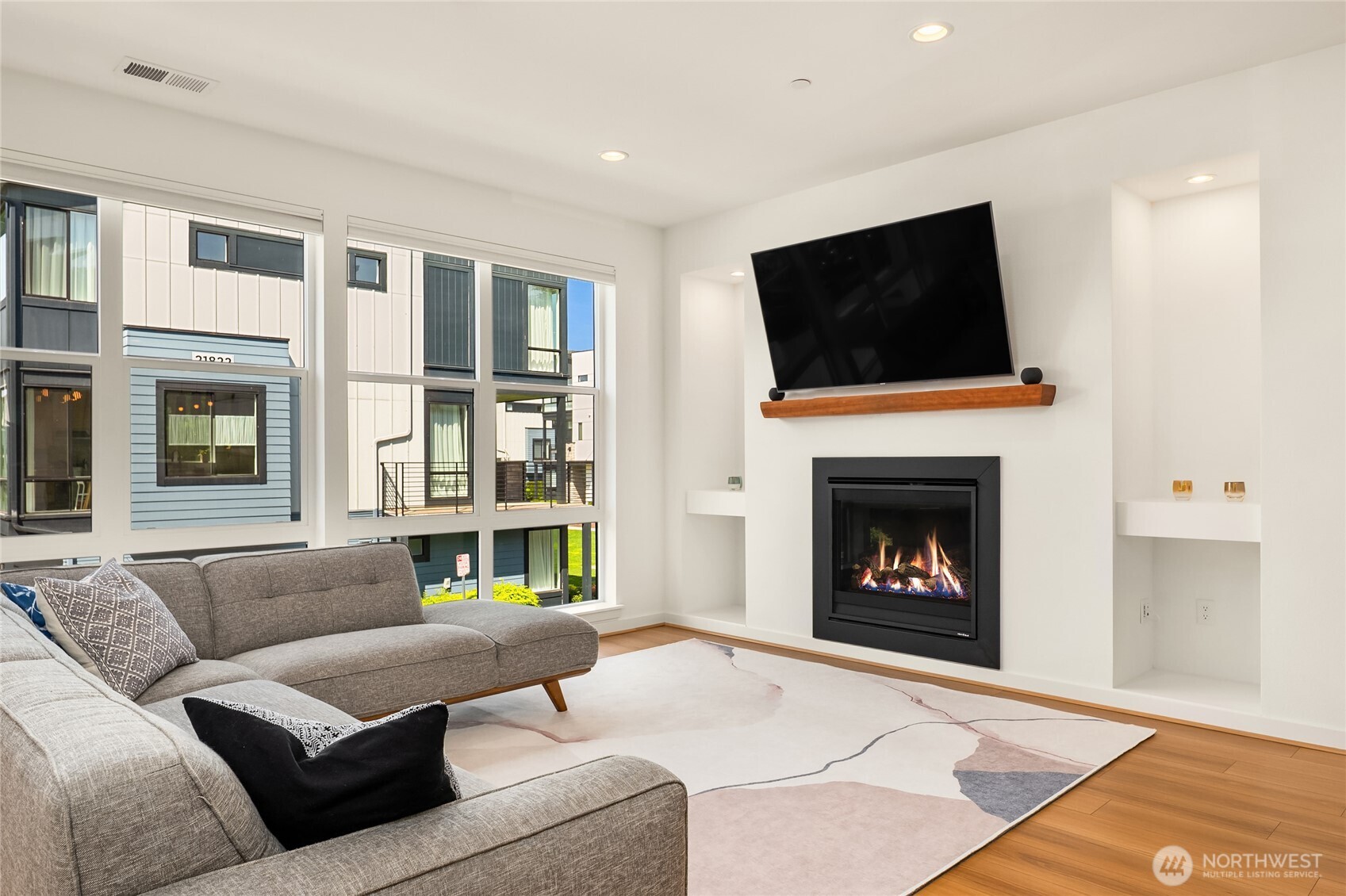 21907 25th Avenue Southeast, Unit C Bothell, WA 98021 - Photo 22 of 40 a living room with furniture a flat screen tv and a fireplace