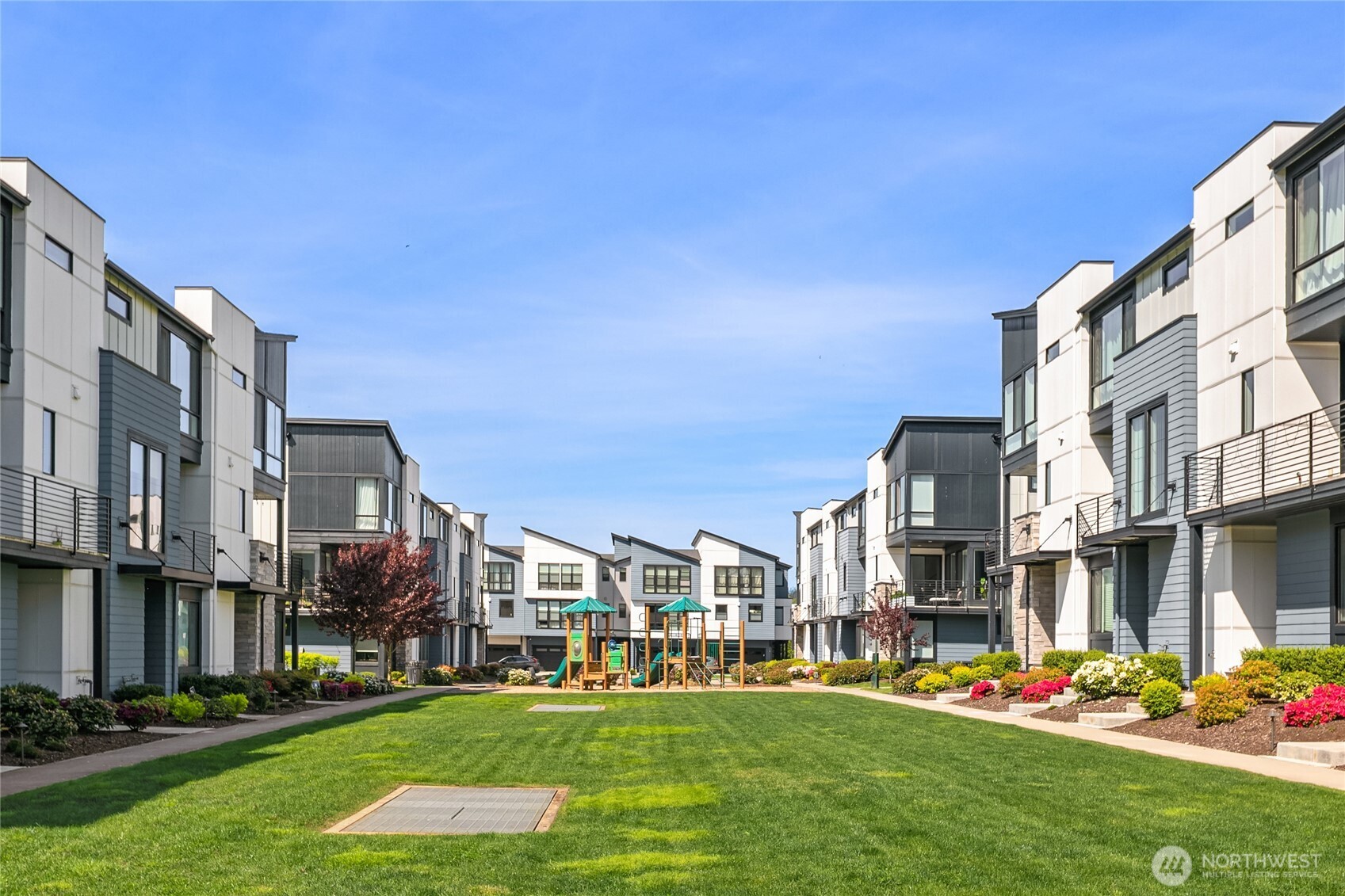 21907 25th Avenue Southeast, Unit C Bothell, WA 98021 - Photo 36 of 40 a front view of a building with play ground and trees