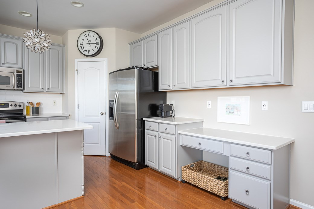 8206 Marvino Lane Raleigh, NC 27613 - Photo 7 of 30 Large pantry and desk area are wonderfully functional additions to the kitchen. Kitchen
