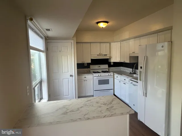 a kitchen with a sink and a stove top oven