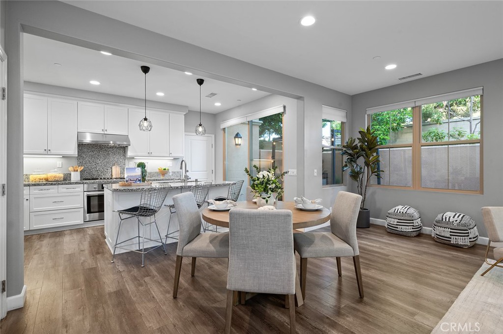 84 Granite Path Irvine, CA 92620 - Photo 11 of 55 a view of kitchen with granite countertop microwave cabinets dining table and chairs