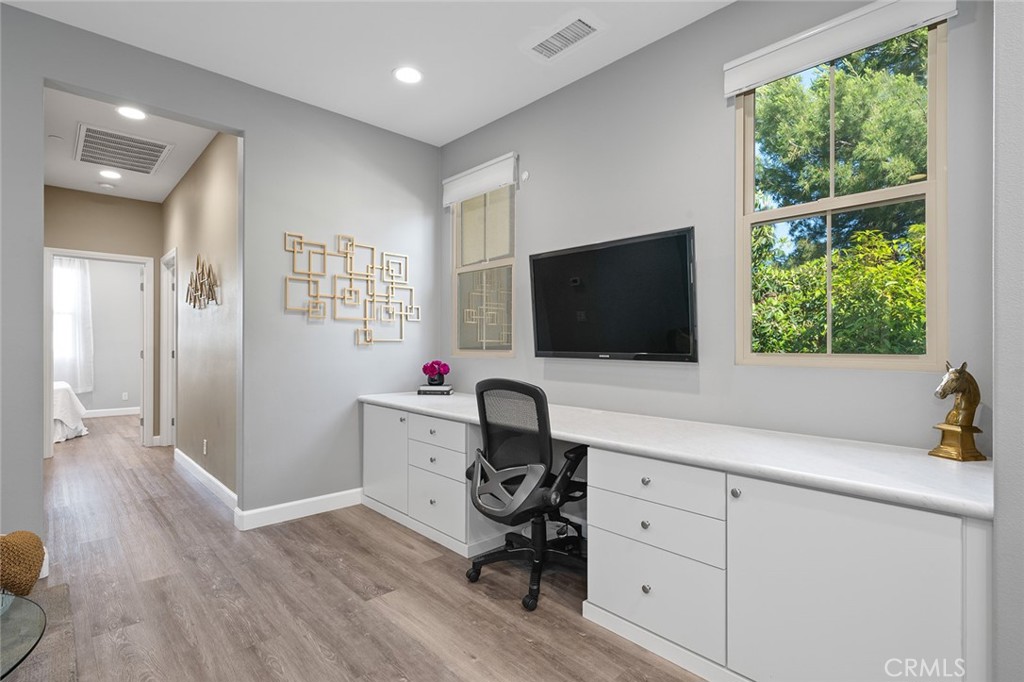 84 Granite Path Irvine, CA 92620 - Photo 23 of 55 a room with a chair and a flat screen tv