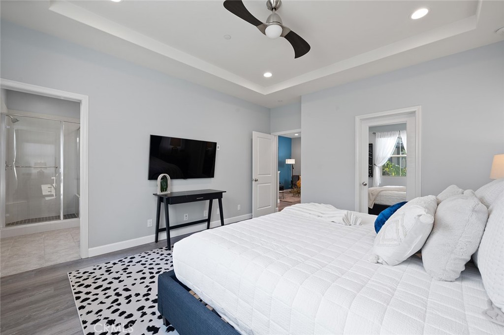 84 Granite Path Irvine, CA 92620 - Photo 27 of 55 a bedroom with a bed and a flat screen tv