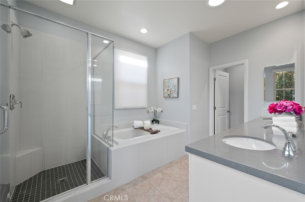 84 Granite Path Irvine, CA 92620 - Photo 28 of 55 a bathroom with a sink double vanity granite tub shower and a mirror
