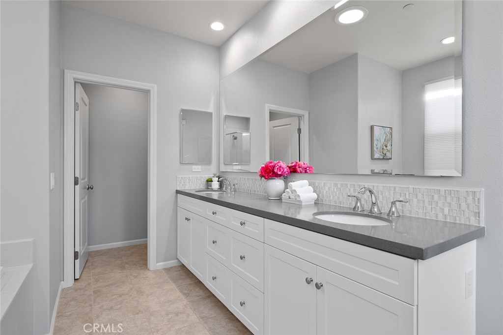 84 Granite Path Irvine, CA 92620 - Photo 29 of 55 a bathroom with a sink vanity and a mirror