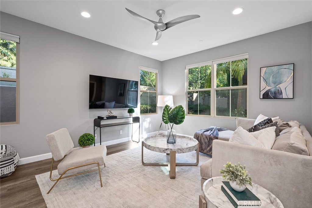 84 Granite Path Irvine, CA 92620 - Photo 3 of 55 a living room with furniture a flat screen tv and a window