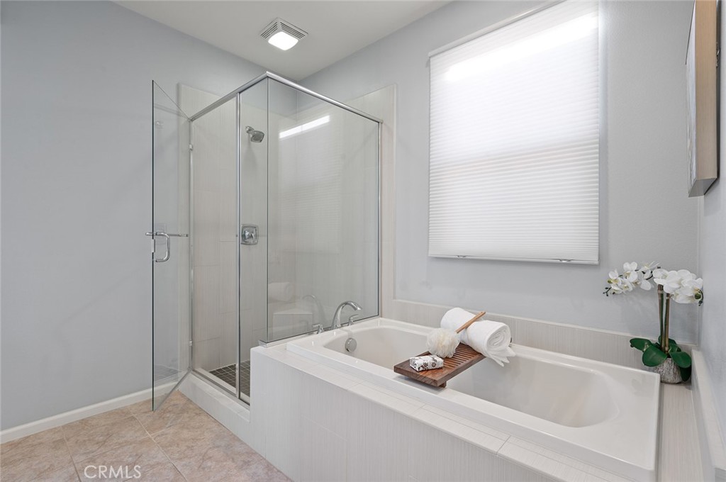 84 Granite Path Irvine, CA 92620 - Photo 31 of 55 a bathroom with a tub a sink and mirror