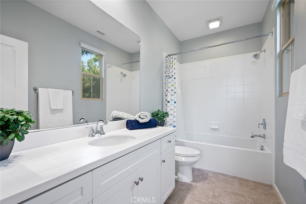 84 Granite Path Irvine, CA 92620 - Photo 39 of 55 a bathroom with a sink a toilet and shower