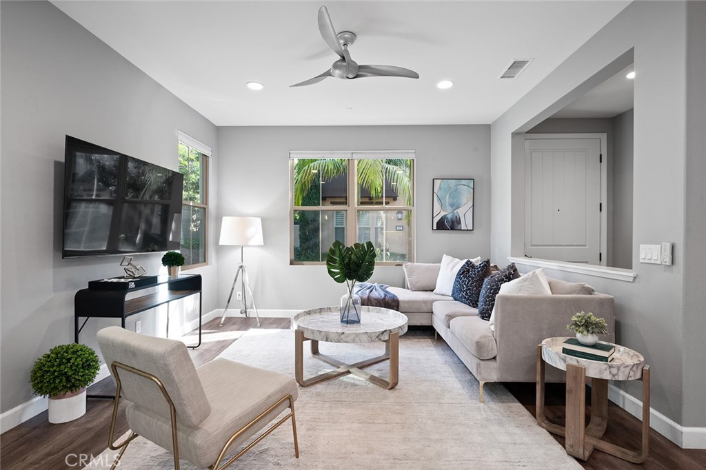 84 Granite Path Irvine, CA 92620 - Photo 4 of 55 a living room with furniture fireplace and a flat screen tv