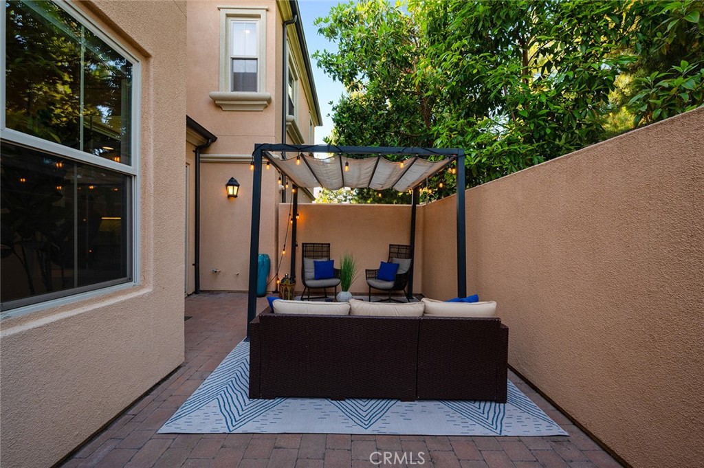 84 Granite Path Irvine, CA 92620 - Photo 46 of 55 a view of a couches and dinning table in patio with a wooden fence