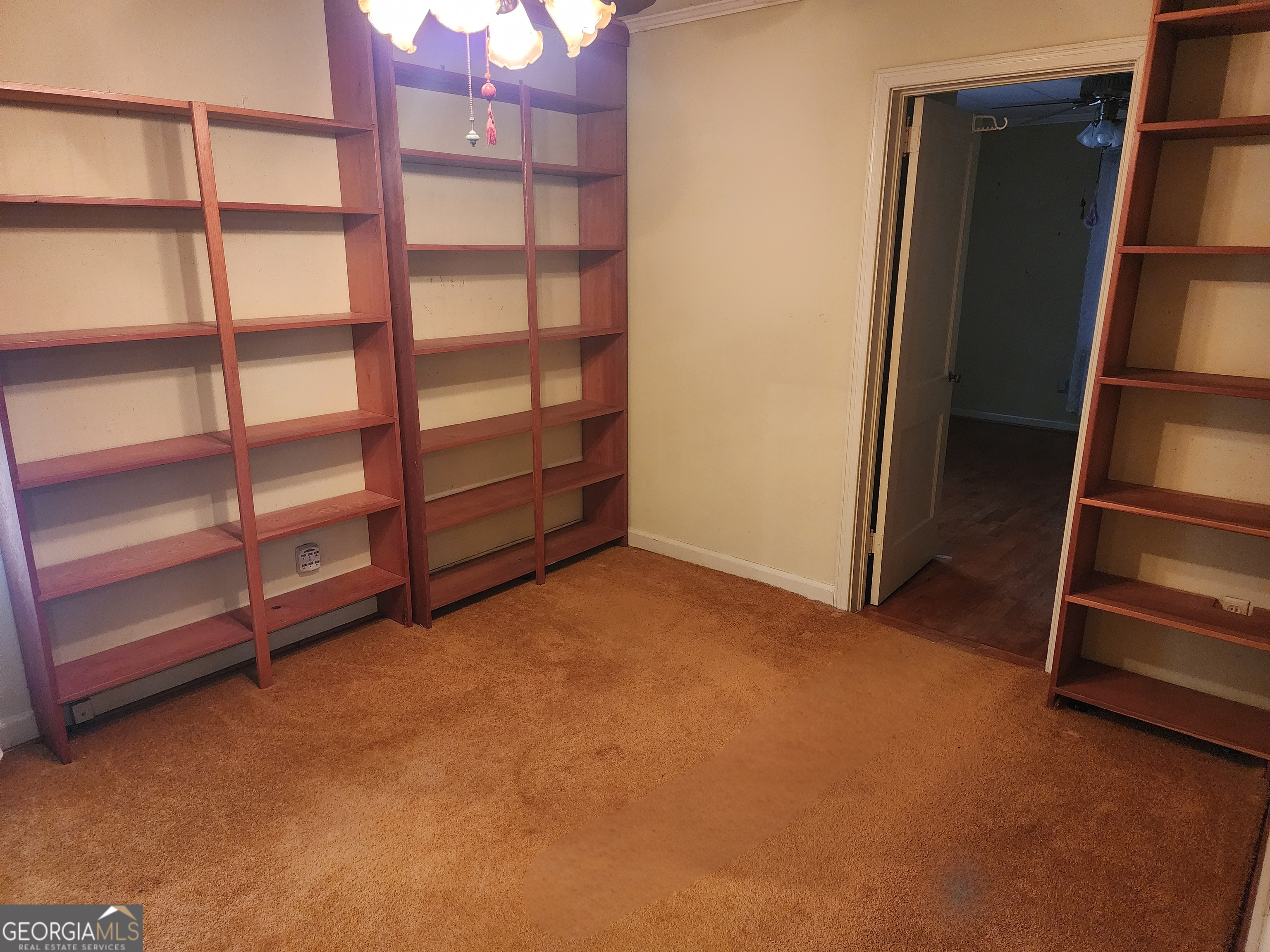 210 Penn Avenue Dublin, GA 31021 - Photo 13 of 17 a view of an empty room with empty shelves
