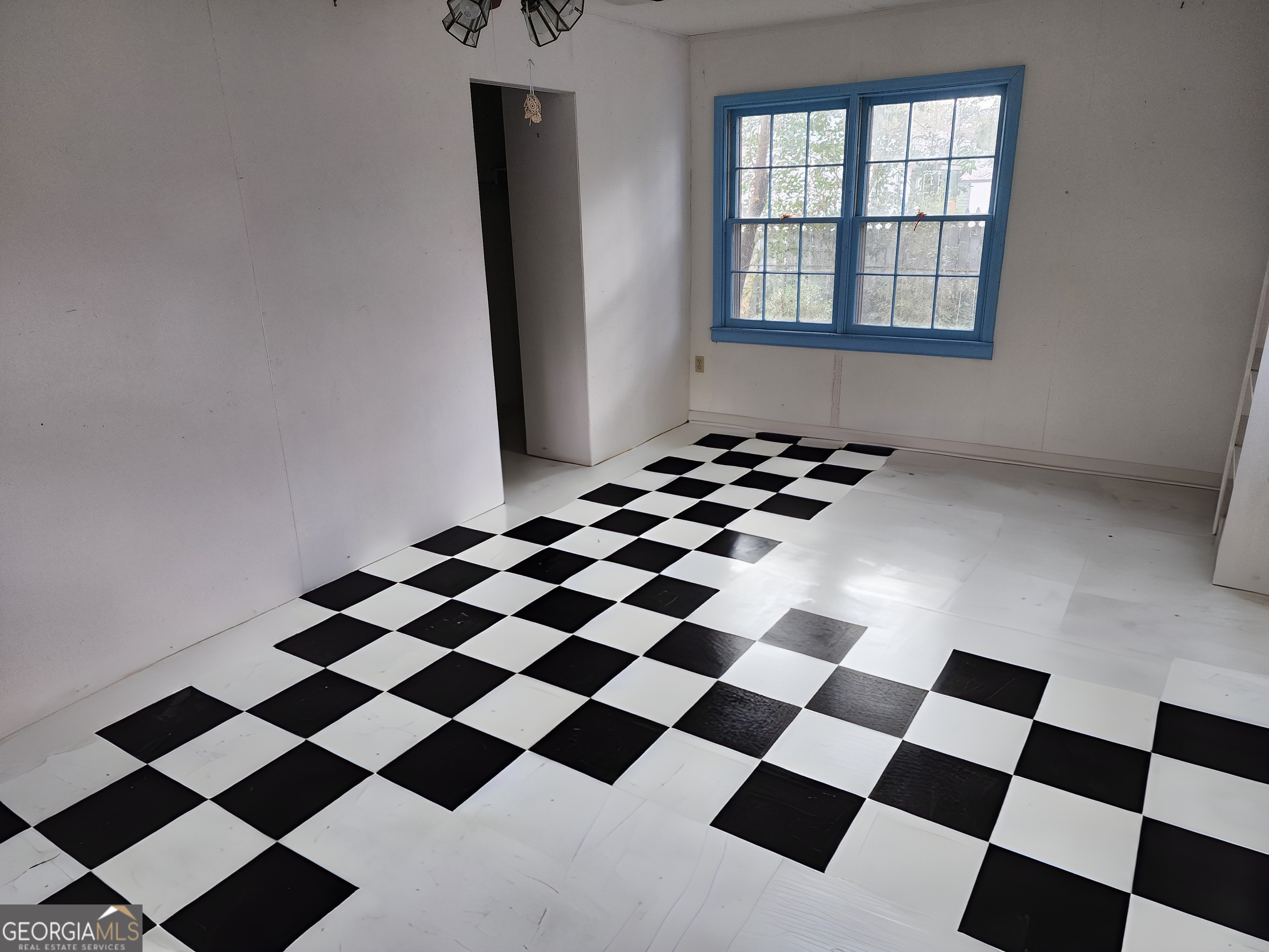 210 Penn Avenue Dublin, GA 31021 - Photo 9 of 17 a black and white checkered floor with a black white checkered floor