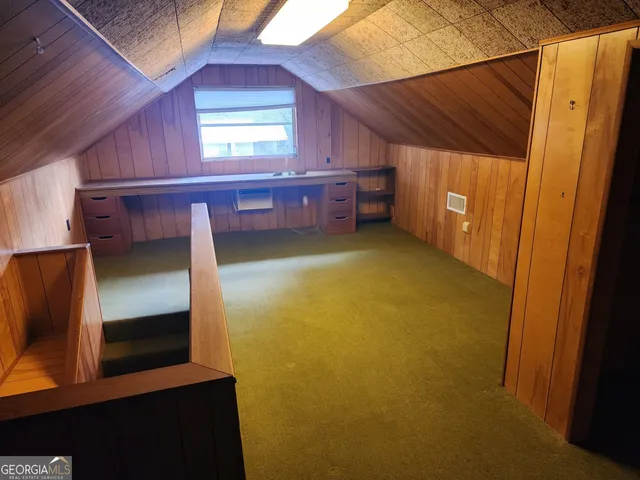 an empty room with windows and chandelier