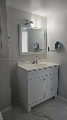 a bathroom with a double vanity sink mirror and