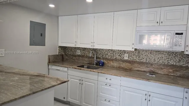a kitchen with appliances cabinets and a counter top space
