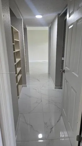 a bathroom with a shower and closet