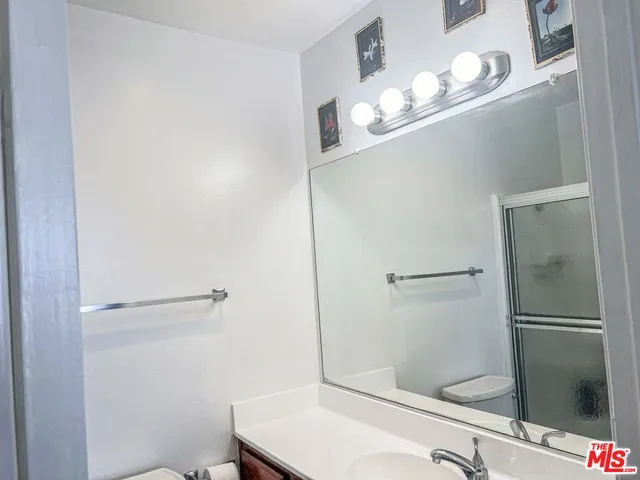 a bathroom with a shower and a sink