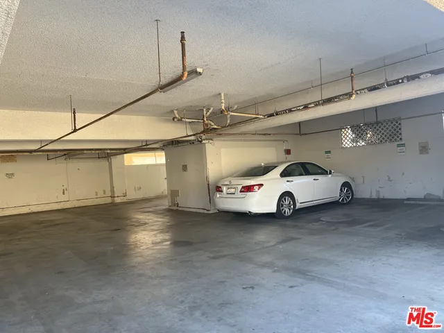 a white car parked in a parking garage