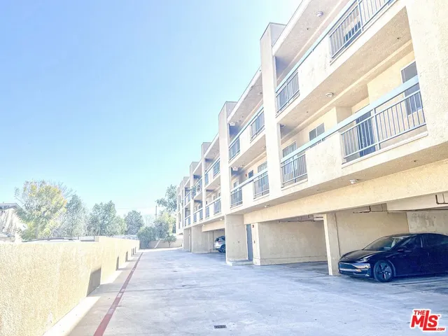 a view of a building with car parked