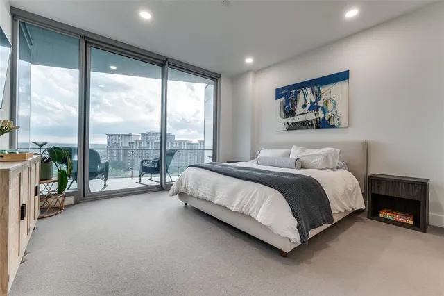 a spacious bedroom with a large bed and a large window