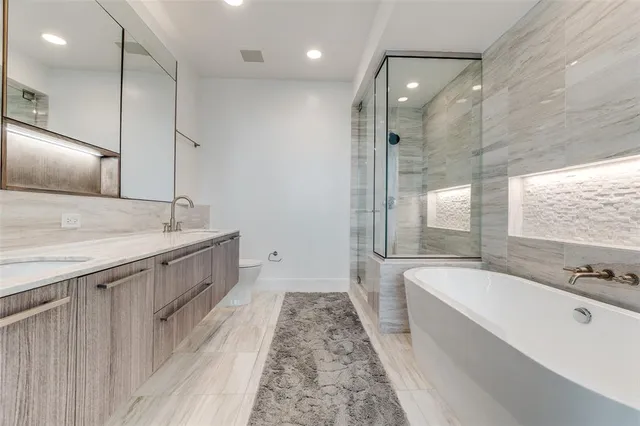 a spacious bathroom with a large tub sink and vanity