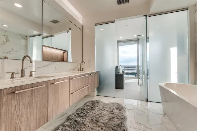 a bathroom with a double vanity sink a mirror and a shower