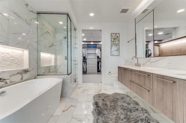 a large spacious bathroom with a large tub shower and sink