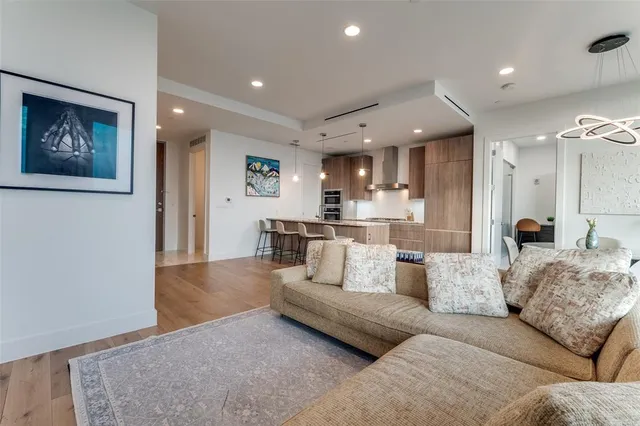 a view of a living room kitchen and a wooden floor
