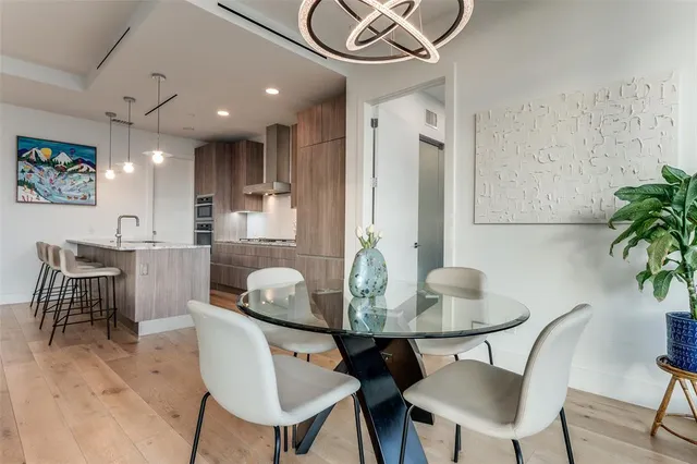 a dining room with furniture and wooden floor